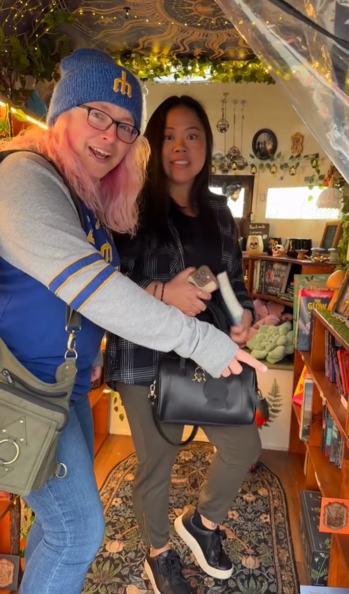 Happy customers browsing books inside the trailer